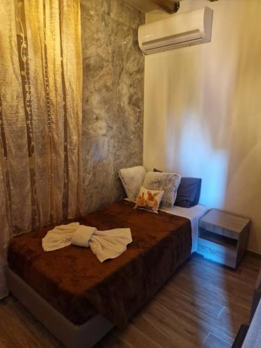 a bedroom with a bed with two towels on it at Errik Luxury House in Faliraki