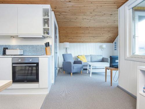 a kitchen and living room with a couch and a table at 4 person holiday home in Lemvig in Lemvig