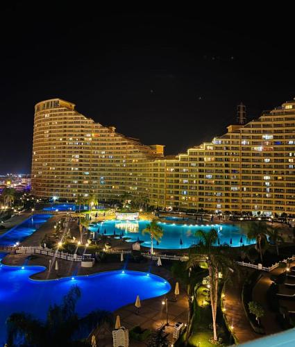a large hotel at night with blue lights at Porto sokhna pyramids in Ain Sokhna