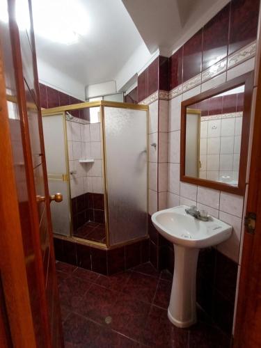 a bathroom with a sink and a shower at Hotel Plaza Grau in Trujillo