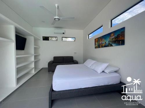 a bedroom with a bed and a chair in it at Casa Aqua in Nilo