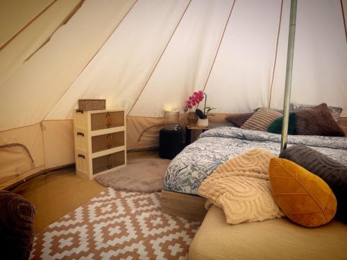 a bedroom with a bed in a tent at La Clef des Ondes in Magescq