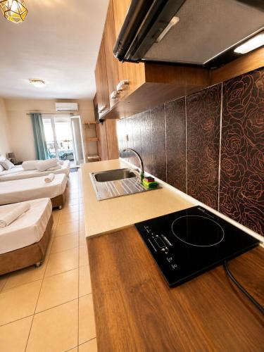 a kitchen with a sink and a counter top at Meltemi Studios Polychrono in Polychrono