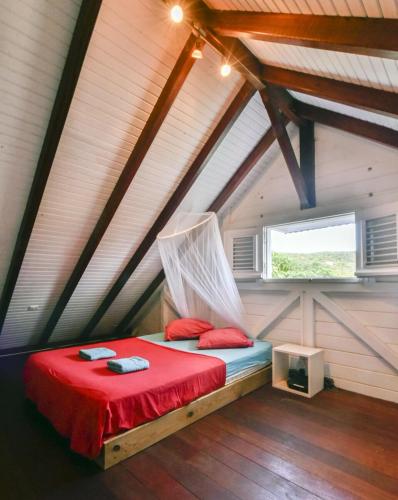 a bedroom with a bed in a attic at Kazabat à Marie-Galante in Grand-Bourg