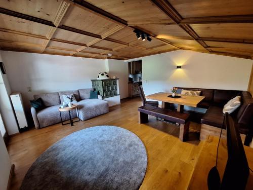 a living room with a couch and a table at Winklern Appartment Wildschütz in Kitzbühel