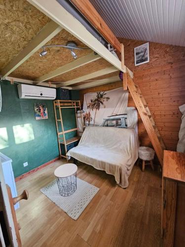 a bedroom with a bed in a attic at Tiny house tout inclus in Fronton