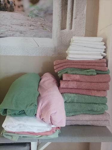 a stack of blankets and pillows on a shelf at Tiny house tout inclus in Fronton