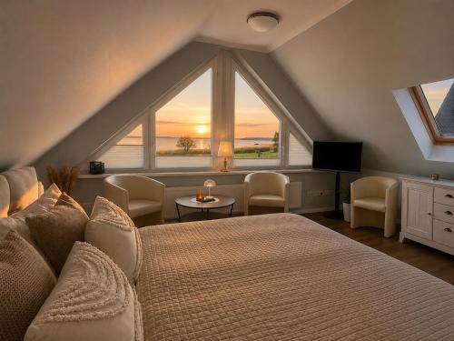 a bedroom with a large bed and a large window at Ferienhaus Am Achterwasser in Ueckeritz