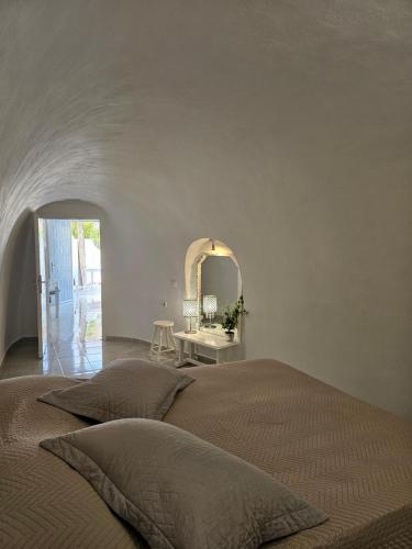 a bedroom with a bed and a mirror at Porto Castello in Fira