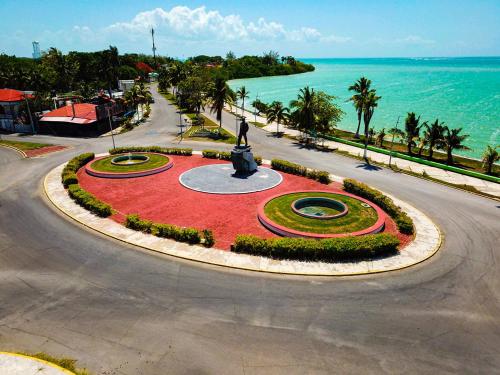 a roundabout with a statue in front of the ocean at Hotel Rosa del Alba, Barrio Mágico Centro Histórico de Chetumal in Chetumal