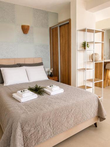 a bedroom with a bed with two towels on it at Milla Terrace Apartment Volos in Volos