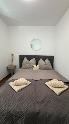 a bedroom with a large bed with two pillows on it at Casa Capri Győr in Győr