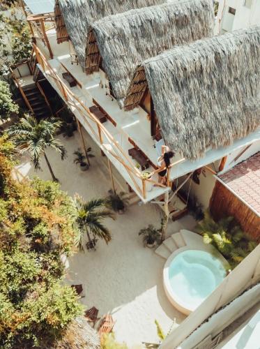 an overhead view of a building with a pool at Casa Balam Holbox, Beach style cabañas in Holbox Island