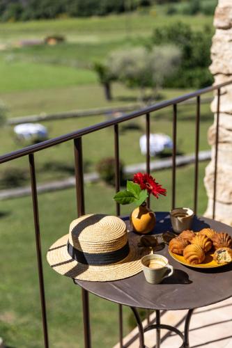 a table with a plate of food on a balcony at Maison Roque in Sannes