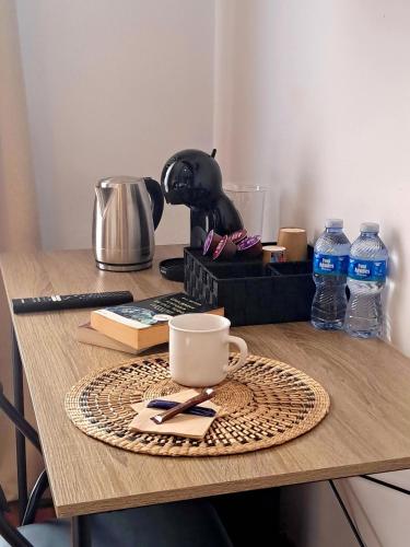 a table with a cup of coffee on a coaster at Villa Allyson Boutique Guesthouse in Lloret de Mar
