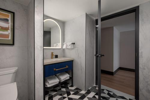 a bathroom with a sink and a mirror at Hotel Indigo Detroit North - Troy by IHG in Troy
