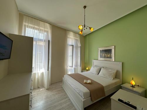 a bedroom with a bed and a tv in it at Theasis Athens in Athens