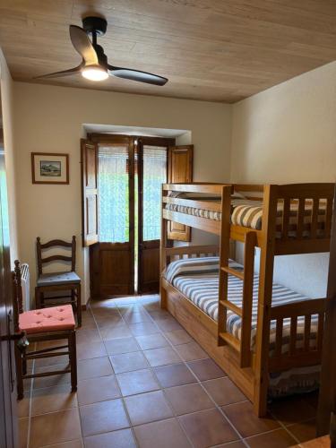 a room with two bunk beds in a house at Cal Nicet in Perafita
