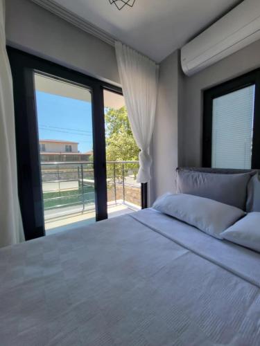 a bedroom with a large bed and a large window at Duplex Villa with Private Pool in Akyaka Ataköy in Muğla