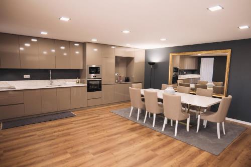 a kitchen and dining room with a table and chairs at Royal Galla Apartment in Macedo de Cavaleiros