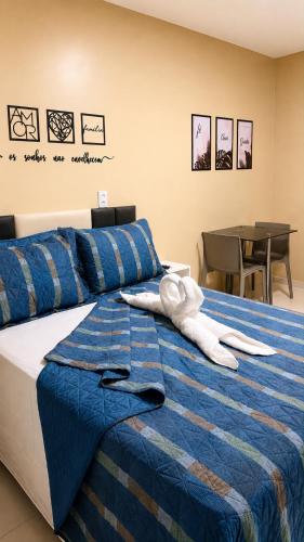 a bed with two white towels sitting on top of it at River Suites Hotel Barreirinhas in Barreirinhas