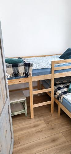 a room with two bunk beds and a door at Fairy- tale house in Przeróbka in Gdańsk