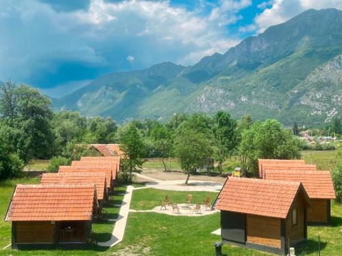 a group of buildings with mountains in the background at ABBA Ethno House in Gusinje
