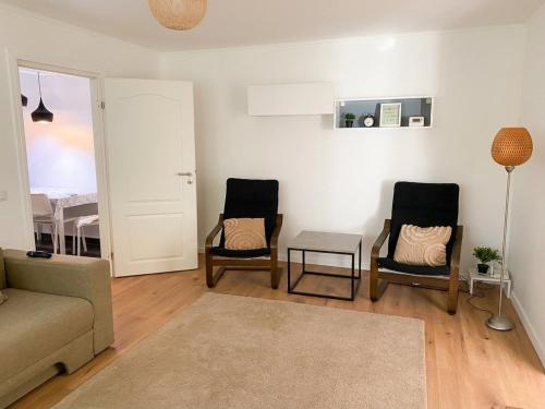 a living room with two chairs and a couch at Marc Apartament in Turda