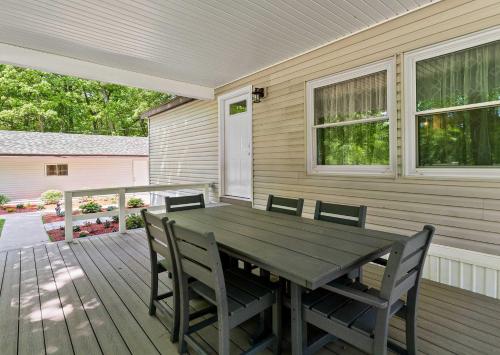 a wooden deck with a wooden table and chairs at Home Field Hideaway in Pullman
