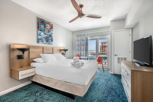 a hotel room with a bed and a flat screen tv at Coconut Palms Beach Resort II, an Ascend Collection Hotel in New Smyrna Beach