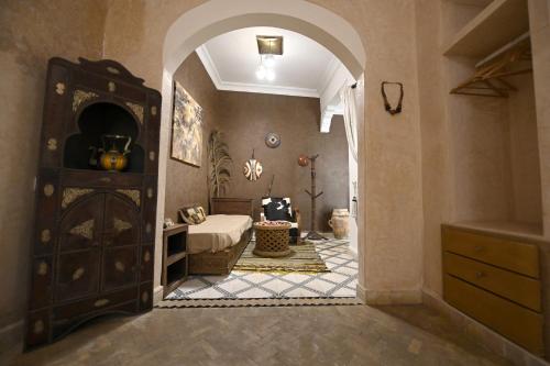 a room with a bedroom with a bed and an archway at Riad MISS CARACAL Jacuzzi & Rooftop in Marrakesh
