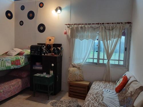 a bedroom with a bed and a window with at El Camino in Gardey