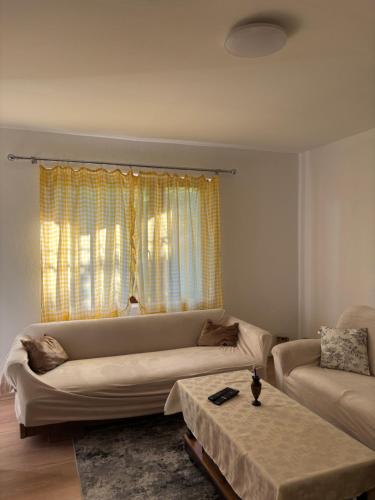 a living room with a couch and a table at EmiliJana House in Dolna Matka