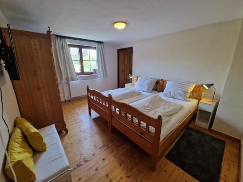 a bedroom with a large bed and a window at Charme im Fachwerkhaus in Sugenheim