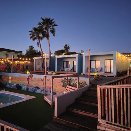 a villa with a swimming pool at night at Ocean's Heaven in Ensenada
