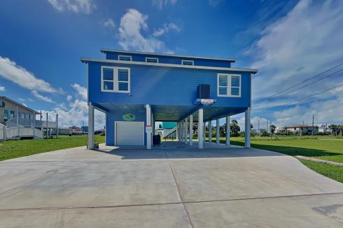 a blue house with a basketball hoop in front of it at Tortuga Moon in Galveston