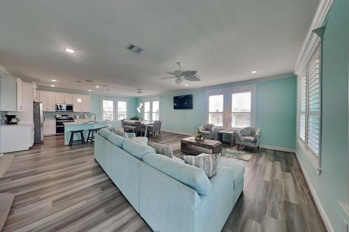 a living room with a blue couch and a kitchen at Tortuga Moon in Galveston
