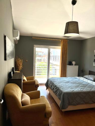 a bedroom with a bed and a couch at palazzo PADINI alla costa in Neoi Epivates