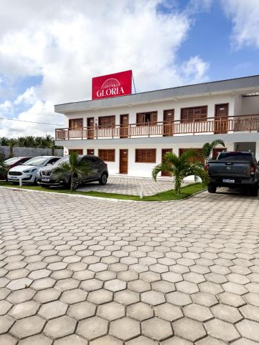 a building with cars parked in front of it at Hotel Glória in Piranhas