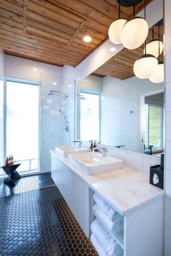 a bathroom with a sink and a large mirror at Duffin Cove Resort in Tofino