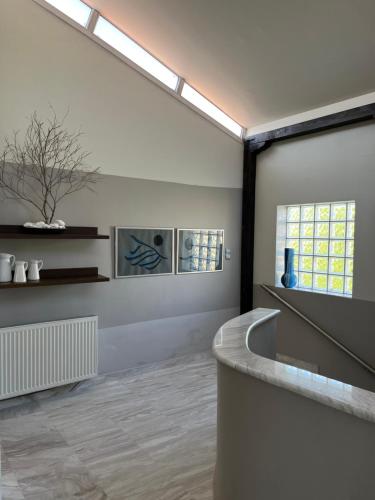 a room with a large window and a bath tub at palazzo PADINI alla costa in Neoi Epivates