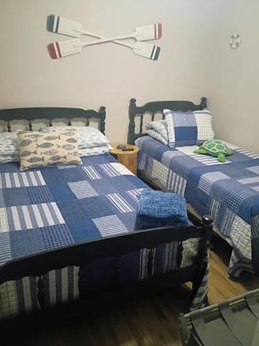 two beds sitting next to each other in a room at Rustic River Cabin in Branford