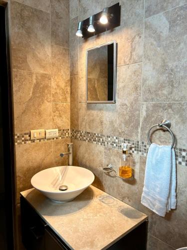 a bathroom with a sink and a mirror at Estudio #2 a 5 min del malecon in La Paz