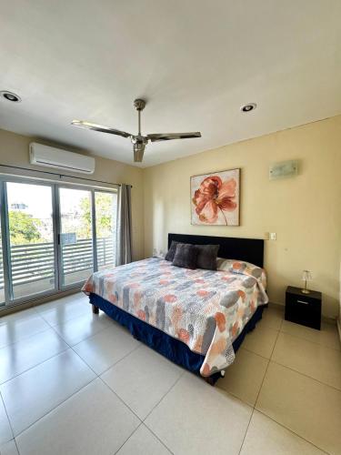 a bedroom with a bed and a large window at Estudio #2 a 5 min del malecon in La Paz