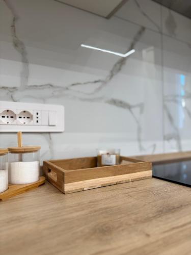 a counter with a wooden cutting board on a table at FraDom House in Montesilvano