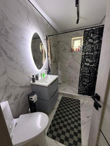 a bathroom with a toilet and a sink and a mirror at Дача на Каролина бугазе in Zatoka