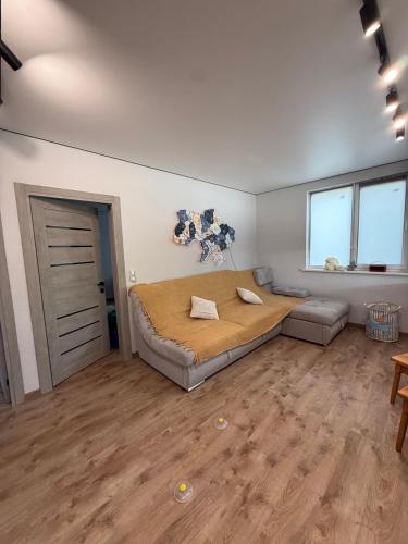 a bedroom with a bed and a couch in a room at Дача на Каролина бугазе in Zatoka