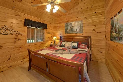 a bedroom with a bed in a log cabin at Mountain View Hot Tub Cabin w Pool Table Romantic in Sevierville