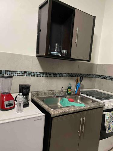 a kitchen with a sink and a counter top at Estudio #3 a 10 min del malecon in La Paz