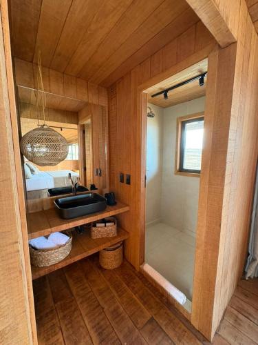 a bathroom with a sink and a shower in a room at Aqua de Mar Condo Hotel in Icaraí